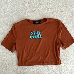 Women’s crop top in dark rust orange in size small.